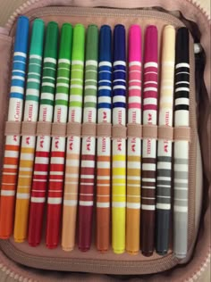 a bag filled with lots of different colored crayons next to eachother