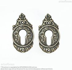 two antique style door knobs on a white background