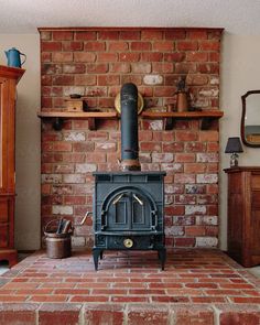 an old fashioned stove in a brick fireplace