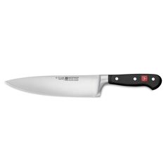 a large knife with a black handle on a white background and red trim around the blade