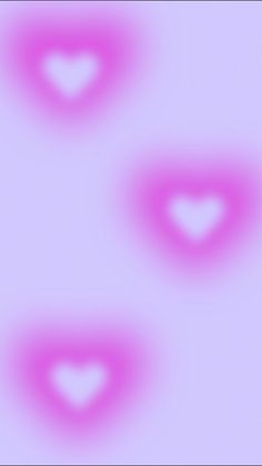 three hearts are shown in the middle of a blurry image with pink and white colors