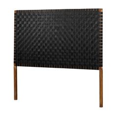 an upholstered headboard with wooden legs and black weaved fabric on it