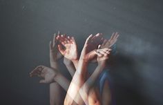 three people reaching up to touch their hands