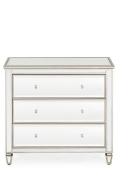 a white dresser with three drawers