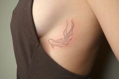 a woman with a bird tattoo on her shoulder