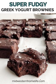 some brownies are cut into squares and sitting on a white surface with the words super fudgy greek yogurt brownies