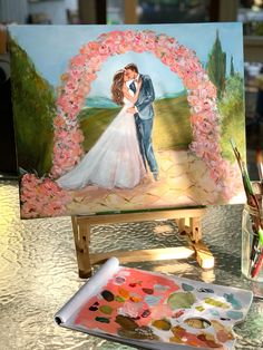 a painting of a bride and groom on an easel