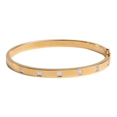 This is part of Chairish’s Fine Jewelry assortment.  This is a beautiful, weighty gold bangle with double baguette diamonds. Perfect in a sophisticated bracelet stack with a diamond tennis bracelet and maybe the evil eye bracelet for a touch of whimsy.  18K Gold; .57 Ct Full Cut diamonds; ; 48 x 58 mm Classic Gold Bangle With Baguette Diamonds, Timeless Baguette Diamond Bangle Bracelet, Gold Bracelets With Baguette Diamonds For Everyday, Everyday Gold Bracelets With Baguette Diamonds, Gold Bangle Bracelet With Baguette Diamonds, Yellow Gold Bangle With Baguette Diamonds, Modern Baguette Diamond Bracelet In Yellow Gold, Modern Gold Bracelet With Baguette Cut, Modern Gold Bracelets With Baguette Cut