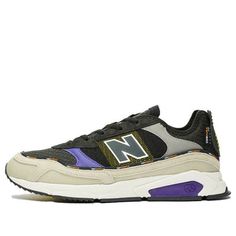 the new balance 997 sneaker in black, grey and purple is available at select shoes