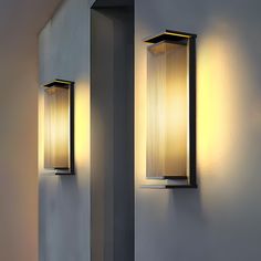 two light fixtures on the wall next to each other