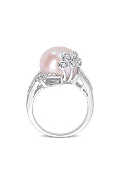 A polished sterling silver ring features a pink cultured freshwater pearl accented by dainty diamonds for luxurious shine. Pearl size: 12–12.5mm Total diamond weight: 0.05ct. Color: G–H Clarity: I3 Sterling silver/cultured freshwater pearl/diamond Imported Diamond Guide Pink Pearl Ring For Wedding, Elegant Pink Diamond Ring With Diamond Accents, Elegant Pink Diamond Ring With Accents, Elegant Pink Ring With Diamond Accents, Elegant Pink Pearl Round Ring, Pink Pearl Ring, Pearl Diamond Ring, Pearl Rings, Pearl And Diamond Ring