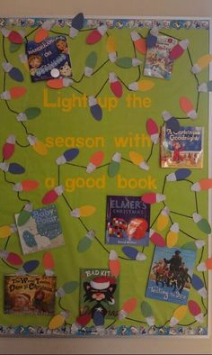 a bulletin board is decorated with books and lights for the holiday season as well as christmas decorations