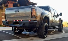 a silver truck parked in front of a house