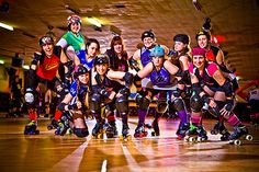 a group of people riding roller skates on top of a hard wood floored floor