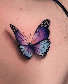 a woman's chest with a butterfly tattoo on it