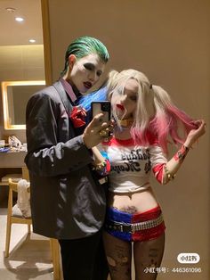 a man and woman dressed up in costumes taking a selfie with a cell phone