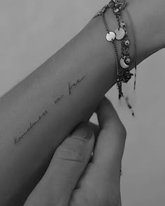 a woman's arm with a tattoo on it that reads, i love you