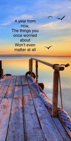 a pier with birds flying over it and the words, a year from now, the things you once wanted to do won't even matter matter