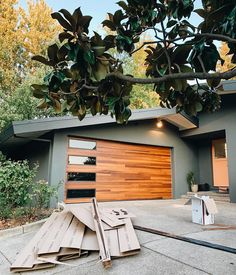 a house that is being remodeled with some wood on the ground and two boxes in front of it