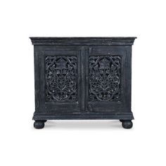 an old black cabinet with carvings on the front and side panels, sitting against a white background