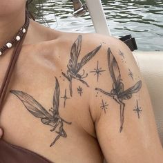 a woman with tattoos on her chest sitting in a boat