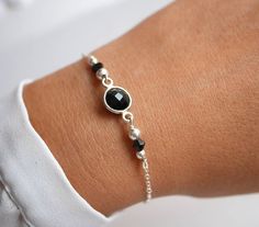 This delicate bracelet is made with sterling silver chain  adorned with one Black round Onyx  stone.➵ Perfect to wear alone or for layering with more bracelets.➵ The bracelet length is ajustable thanks to 5 cm extender chain.➵ Others Black Onyx stone jewels : https://www.etsy.com/fr/listing/542189393/bracelet-double-tours-bracelet-chaine?ga_search_query=onyx&ref=shop_items_search_1https://www.etsy.com/fr/listing/542190619/lot-de-2-colliers-collier-y-collier?ga_search_query=onyx&ref=shop_ Elegant Black Bracelets With Silver Chain, Elegant Black Bracelet With Silver Chain, Black Silver Chain Bracelet As Gift, Black Silver Chain Bracelet For Gift, Black Silver Chain Bracelet Gift, Silver Onyx Beaded Bracelets As Gift, Silver Onyx Beaded Bracelets For Gift, Black Sterling Silver Bracelets With Silver Beads, Black Sterling Silver Bracelet For Gift