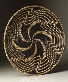 a black and gold basket with an intricate design