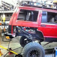 an off road vehicle is being worked on in a garage