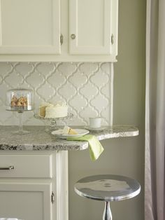 a kitchen counter with a cake on it and some other items sitting on the counter