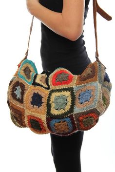 a woman carrying a multicolored crocheted purse