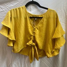 Size Small Moon River Yellow Shirt. Ruffles On Sleeves With Tie And Buttons In Center Shirt Crops Just Above Belly Button Super Pretty For Summer/Fall Fashion. New With Tags, Never Worn, And Comes With Extra Button. Summer Cropped Blouse For Brunch, Short Sleeve Rayon Tops For Brunch, Rayon Short Sleeve Tops For Brunch, Summer Rayon Blouse For Brunch, Gold Button-up Top For Summer, Yellow Button-up Blouse For Vacation, Summer V-neck Rayon Shirt, Trendy Gold Button-up Top, Button-up Rayon Top For Beach