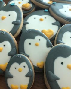 decorated cookies with penguins on them sitting on a table