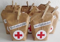 small brown bags with red cross stickers on them