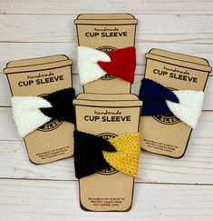 four cup sleeves with different colors and designs in them on a white wooden table top