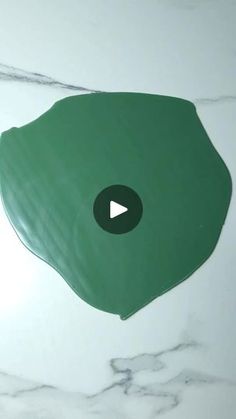 an image of a green object on the floor that looks like it has been made out of paper