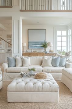 a living room filled with white furniture and lots of windows