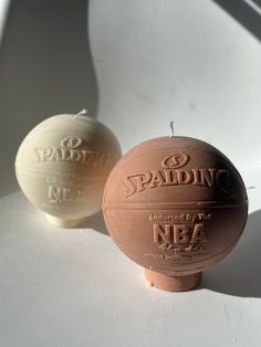 two brown and white balls sitting next to each other