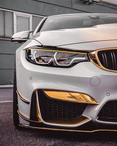 the front end of a white bmw car