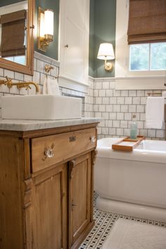 the bathroom is clean and ready to be used as a bathtub, sink, and mirror