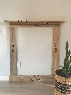 a plant in a basket sitting next to a white wall with measurements for the frame