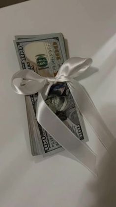 a bundle of money tied to a white ribbon