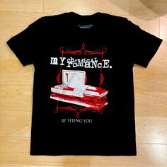 a black t - shirt with an image of a sewing machine on it