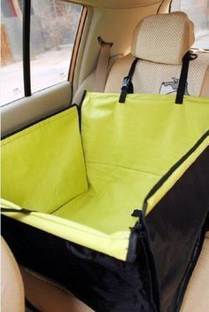 a car seat cover that is in the back of a car, with a black and yellow lining