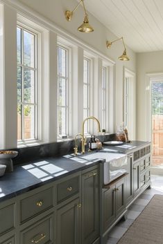 a large kitchen with two sinks and several windows