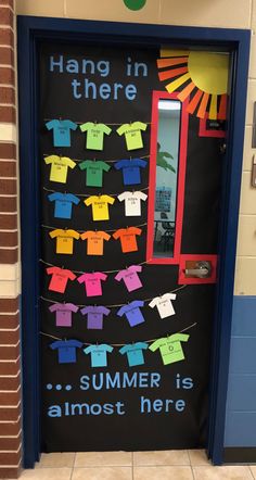 a classroom door decorated with clothes hanging in there and the words summer is almost here