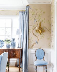 a blue chair sitting in front of a window