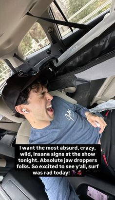 a man in the back seat of a car with his mouth open