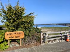 a wooden sign that says shelter cove view point