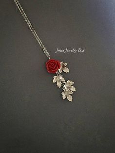 Beautiful red resin rose with dangling silver leaves. Detailed stainless steel leaves measure 15.5mm x 11mm. Total pendant length with rose and leaves is just over 2 inches. This necklace is 18'' long with lobster clasp. *15mm Resin rose *Stainless steel chain *Stainless steel leaves *Handmade with love <3 Like Jmesjewelrybox on Facebook for updates on new jewelry, upcoming sales and giveaways! Plus Facebook fans save 5% :D Find the coupon code on Jmesjewelrybox's cover photo https://www.face Elegant Rose Red Necklace With Rose Design, Red Roses Necklaces For Gift, Red Rose Design Flower Necklace, Red Floral Rose Design Necklace, Red Rose Design Flower Pendant Jewelry, Rose Branch, Resin Rose, Dangle Necklace, Branch Necklace