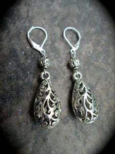 "PLEASE PAY ATTENTION TO PRODUCTION AND SHIP TIMES AS THEY MAY BE LONGER THAN OTHER SELLERSTHANK YOU! silver filigree teardrop shaped pierced earrings. Your choice of lever back or shepherd hook wires. Slightly over 1 1/2\" in total length. Nice quality pewter silver filigree charms. Comes gift boxed with ribbon.Please be aware that my current production time is 1-2 weeks, although I will make every effort to get your order out to you as soon as possible.YOUR SHIP DATE WILL BE EMAILED TO YOU BY Ornate Nickel-free Teardrop Dangle Earrings, Ornate Filigree Teardrop Dangle Earrings, Silver Filigree Teardrop Earrings For Gift, Ornate Silver Nickel-free Teardrop Earrings, Ornate Silver Teardrop Pierced Earrings, Ornate Silver Teardrop Earrings, Sterling Silver Teardrop Earrings With Intricate Design, Sterling Silver Intricate Teardrop Earrings, Ornate Dangle Teardrop Earrings